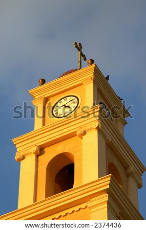 Clock tower with a cross in Jaffo, Israel - catholic church inside arab town