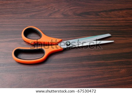 Scissors on wood background