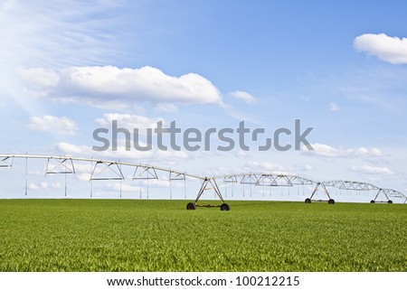 Center pivot irrigation system on a green field