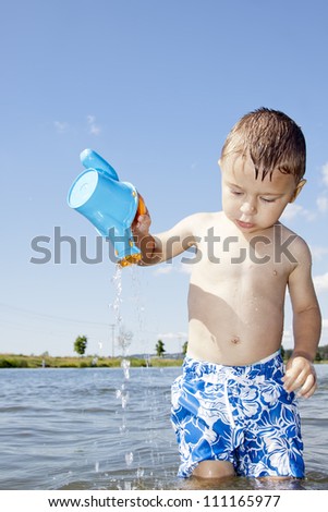 child play with plastic toys in the water