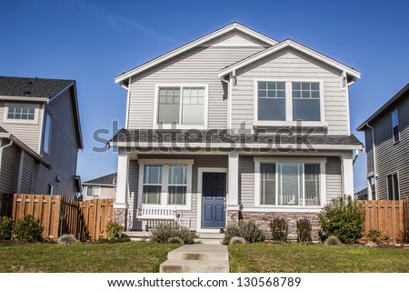 Single family house with two levels and blue sky on background