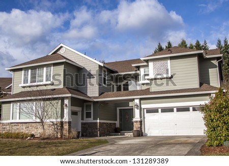 Suburban home with front porch,garage and blue sky