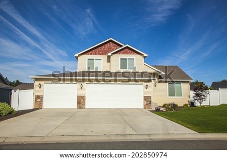 luxury family house with landscaping on the front and blue sky on background
