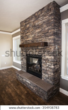 fireplace built with stone and wooden mantel