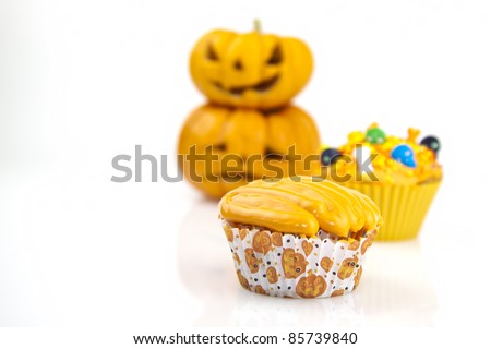 orange halloween cupcake decorated candies on a white background