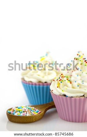 sweet cupcakes decorating white frosting on a white background