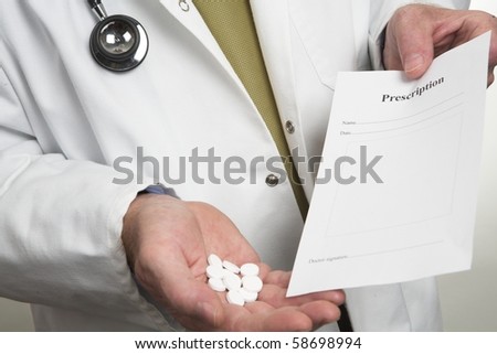 Doctor holding prescription and pills