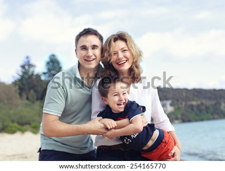 happy family outdoors on a beach smiling