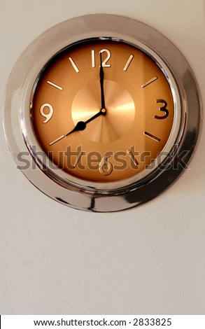 Clock hanging on the wall. It is indicating eight o\'clock - time to start working.