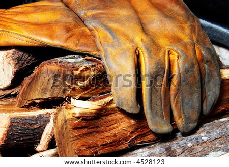 Leather gloves lying on a wood pile