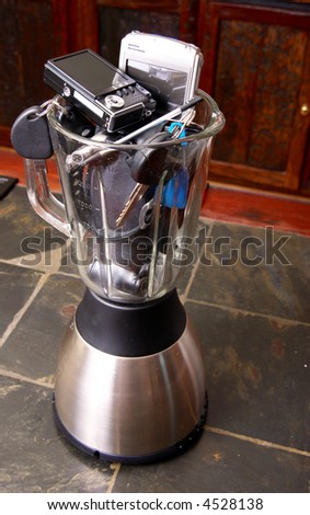Business equipment in a blender standing on a tiled counter