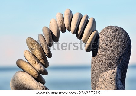 Arch of pebbles between of the stones on the coast