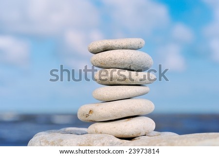 Six sea stones put against each other at the sea