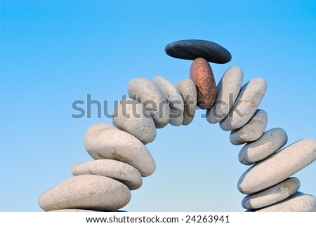 White sea pebble combined in an arch with a black stone with top