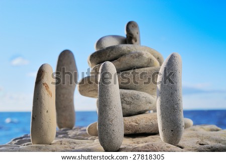 Group of cobble-stones on the shores of ocean as an ancient symbol