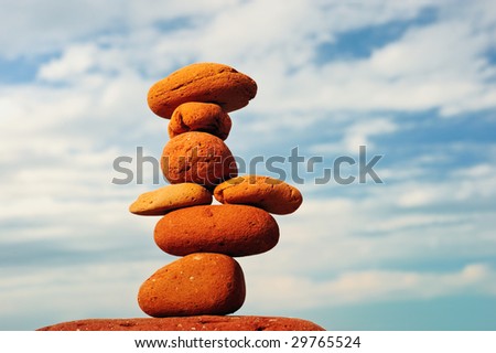 Pyramid of red-cobble-stones on a background of blue sky