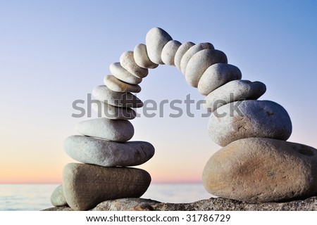 Arch of the white pebbles on the coast in the morning