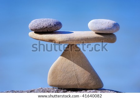 Pair of scales is made of stones on the cliff