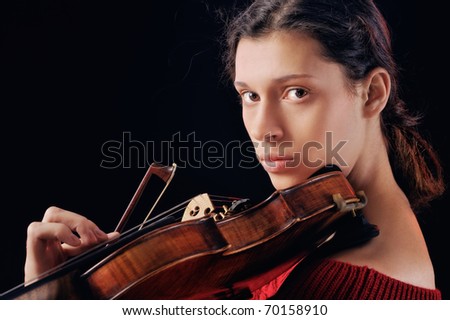 Musician playing violin. Isolated on the black background
