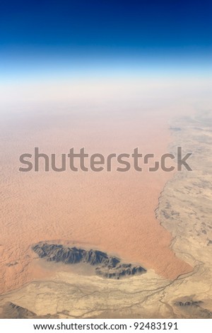 Aerial view of barren desert and rocks