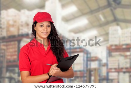 Young worker with red uniform and clipboard at work