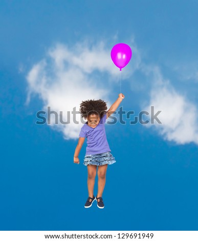 African little girl flying with a purple balloon through the sky
