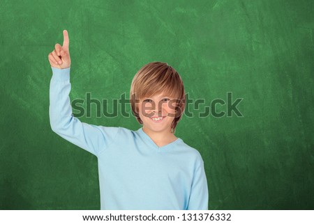 Happy student asking to speak with a green blackboard of background