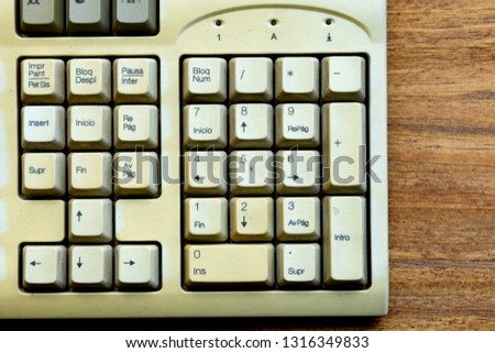 Old keyboard of a computer on a wooden background