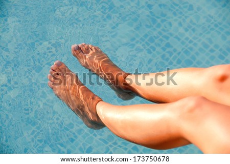Nice Legs Of Woman Soaking Feet In Swimming Pool