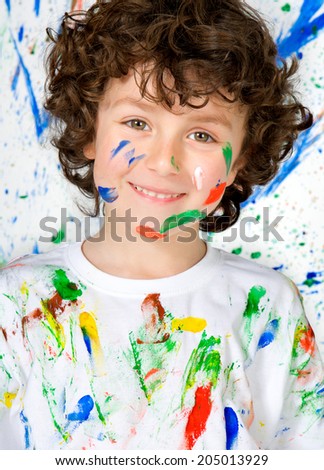 Funny child with painted face after a painting class