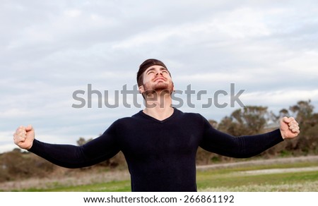 Handsome guy with open arms celebrating something