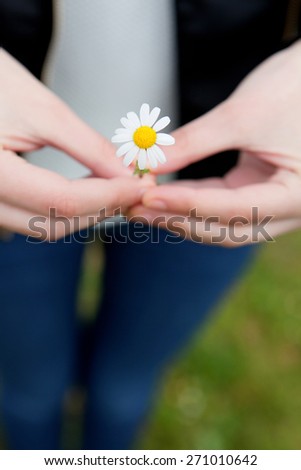 Woman with a flower in her hand. Spring came