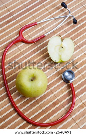 stethoscope and apple (a healthful food and heals)