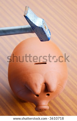 Hammer breaking a money box (Focus in the hammer)
