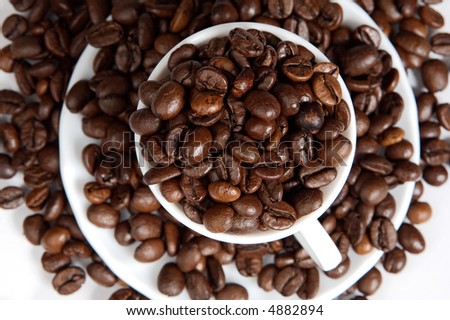 Coffee beans in a cup (focus in the first plane)