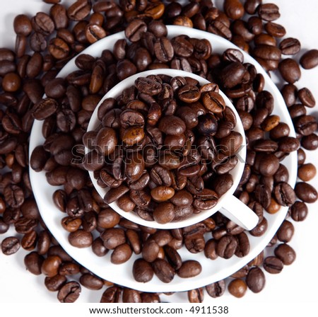 Coffee beans in a cup (focus in the first plane)