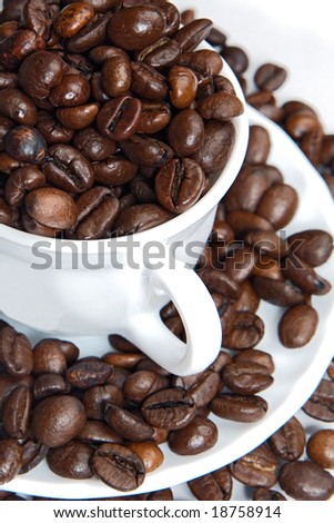 Coffee beans in a cup  - focus in the first plane -