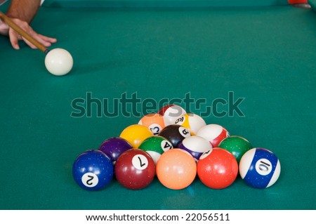Playing billiards with balls on a green felt table