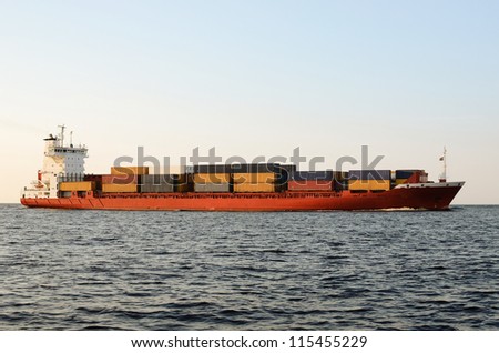 cargo container ship sailing at the sunset