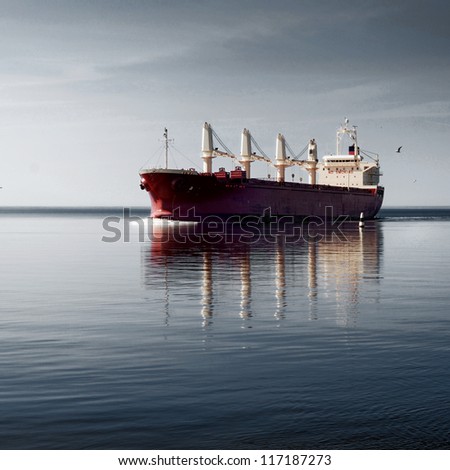 cargo ship sailing in still water near port of Riga cargo ship sailing in still water near port of Riga