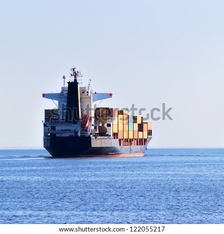 cargo ship sailing in still water