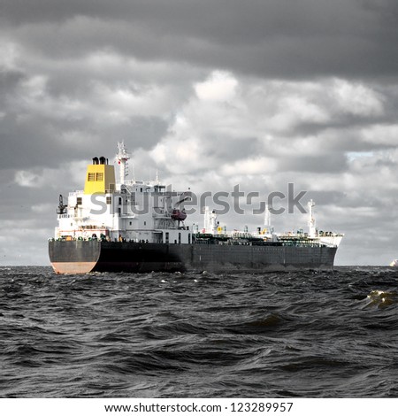 cargo ship sailing in stormy weather near port of Riga