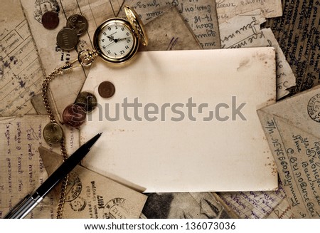 vintage pocket clock, pen and money on old letters texture