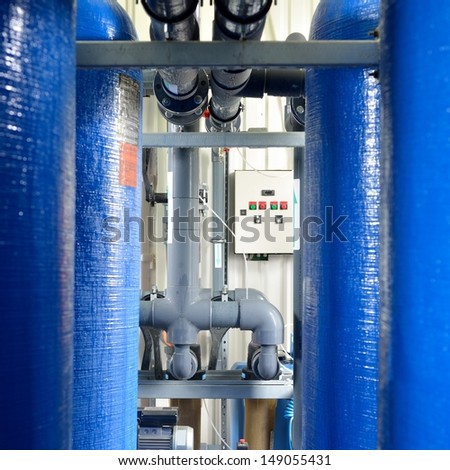 industrial large blue tanks and water pipeline in a boiler room