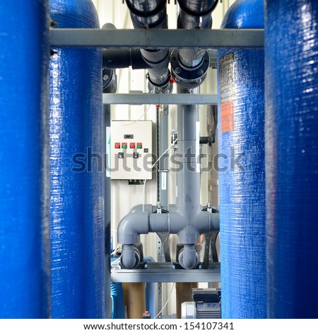 industrial large blue tanks and water pipeline in a boiler room