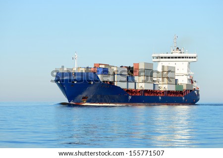 cargo container ship sailing in still water