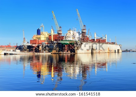 cargo ship are during fixing and painting at the shipyard docks