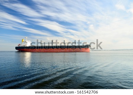 Large cargo ship sailing in still water