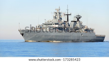 Grey modern warship sailing in still water Grey modern warship sailing in still water