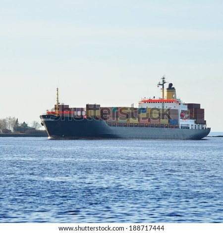 Large cargo container ship sailing. Riga, Latvia